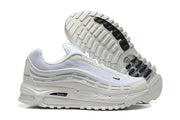 Side and outsole views of white Nike sneakers with black outsole accents.