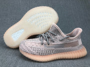 Three-quarter view of the pair with one shoe lifted to show the translucent outsole pattern.