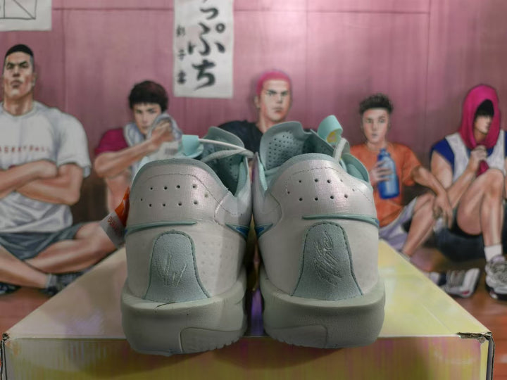 Rear view of white and blue Nike sneakers showing perforated heel panels, grey heel details, and the outsole.