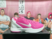 Side profile of a pink and white Nike basketball sneaker showing the textured upper, white Swoosh, white midsole, and translucent heel.