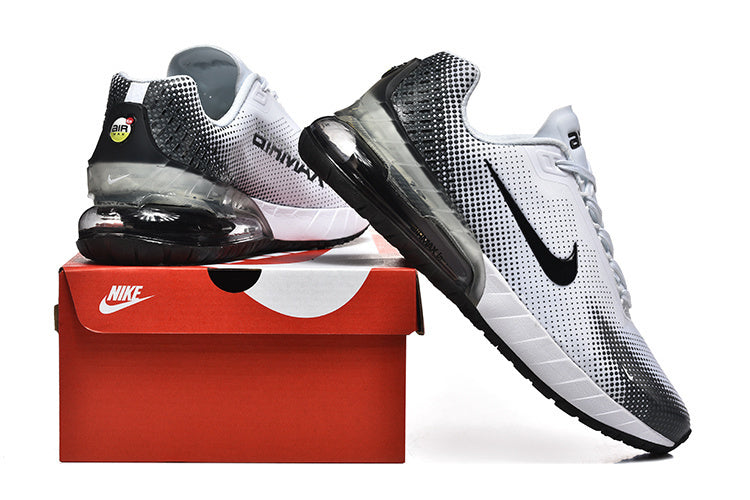 White and black Nike Air Max sneakers displayed with a red Nike shoe box.