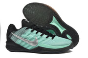 Side view of a green basketball shoe with metallic-silver side logo and outsole detail