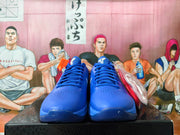 Front view of blue Nike Kobe basketball shoes with lace-up closures and perforated toe panels.