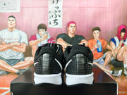 Rear view showing patterned heel panels on black and white Nike shoes