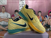 Angled view of the yellow and green basketball sneaker pair showing the side Swoosh, padded collars, laces, and layered outsole.