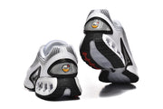 Rear and outsole views of white and black Nike Air Max DN sneakers.