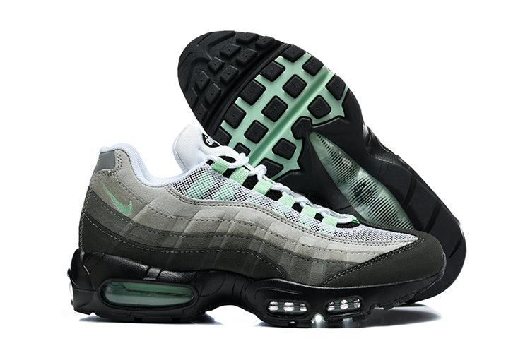 Side view of grey and black Nike Air Max 95 TT sneakers with mint-green accents and visible Air units, including an outsole view.