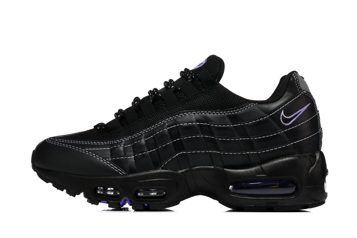 Side view of a black Nike Air Max 95 sneaker with layered panels, contrast stitching, mesh upper, and purple accents.