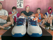 Front view of the blue and white Nike sneakers showing dark purple laces, blue tongue accents and contrasting toe outsole details.