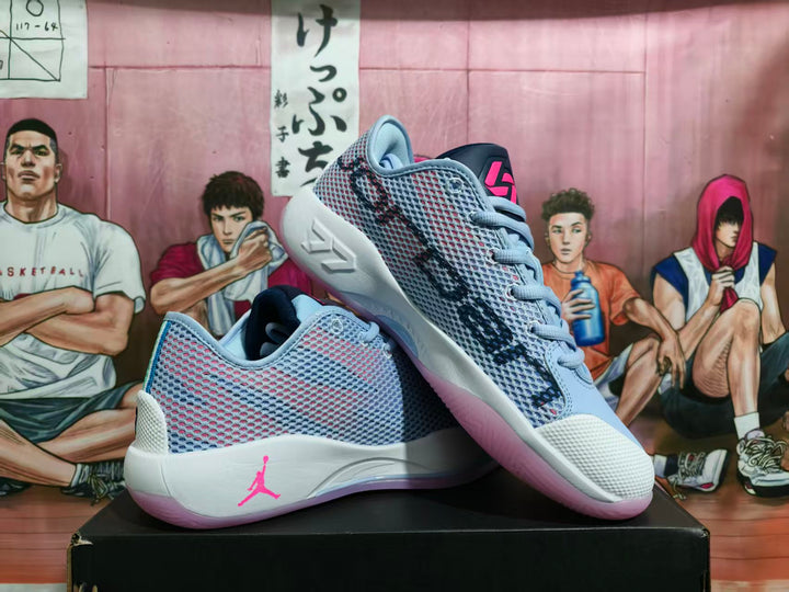 Pair of light blue and white Jordan basketball sneakers with pink and purple accents displayed on a black shoebox.