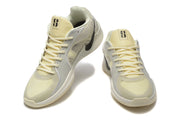 Pair of pale yellow and light gray Nike Kobe 5 Protro shoes shown from front and side