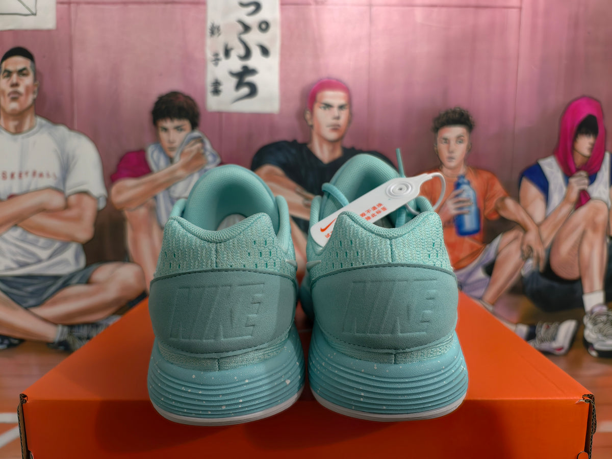Rear view of mint green Nike sneakers showing the padded collars, heel panels and layered ribbed soles.