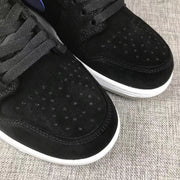 Close-up of the black perforated toe panels and black laces.
