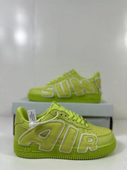 Close side view of the green sneaker showing the outlined Air Force lettering, perforated toe, and lace area.