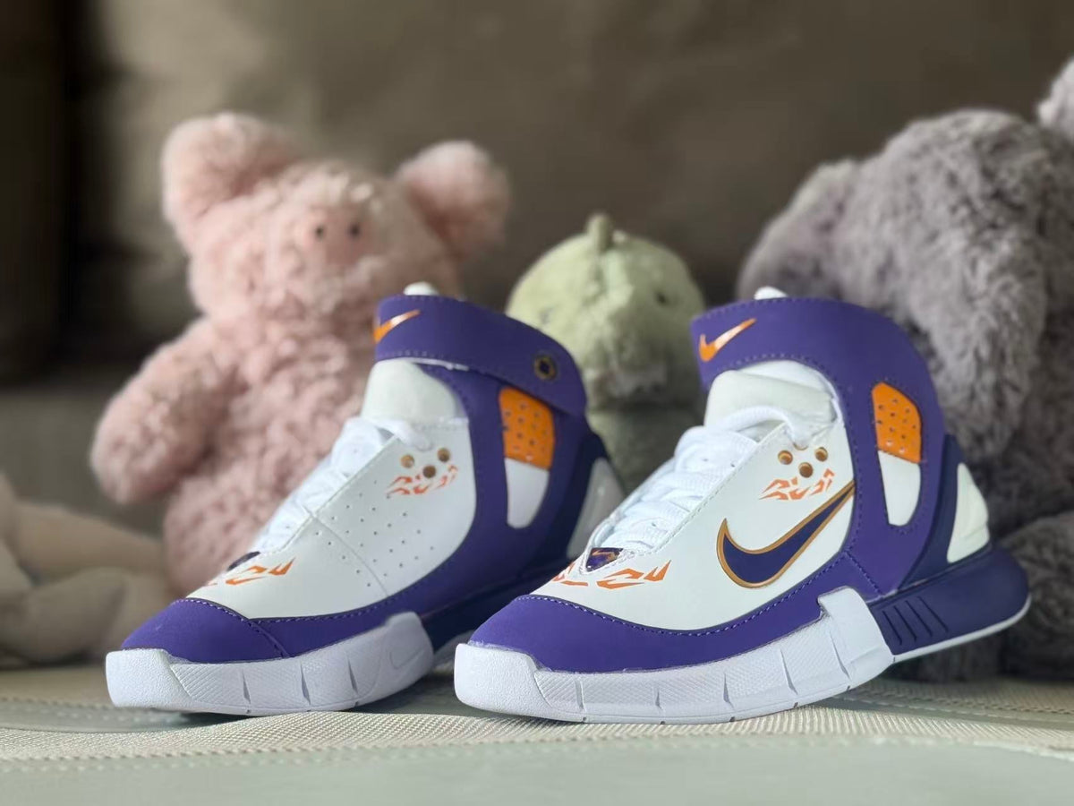Pair of purple, white, and orange kids’ high-top sneakers shown from the front.