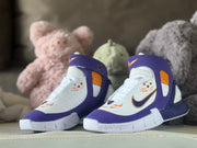 Pair of purple, white, and orange kids’ high-top sneakers shown from the front.