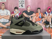 Side view showing the olive green upper, black mesh panels and lace supports, off-white midsole, and heel air unit.