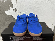 Front view of blue lace-up Converse training-style shoes with gum-colored soles