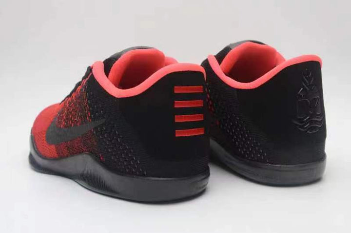 Rear view of red and black Nike Kobe 11 basketball shoes with coral-pink collar lining.