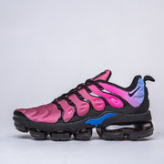 Side profile of a pink, black, and blue Nike sneaker.
