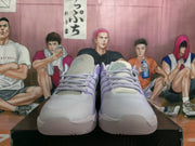 Front view of the light gray sneakers with lavender accents and gray laces