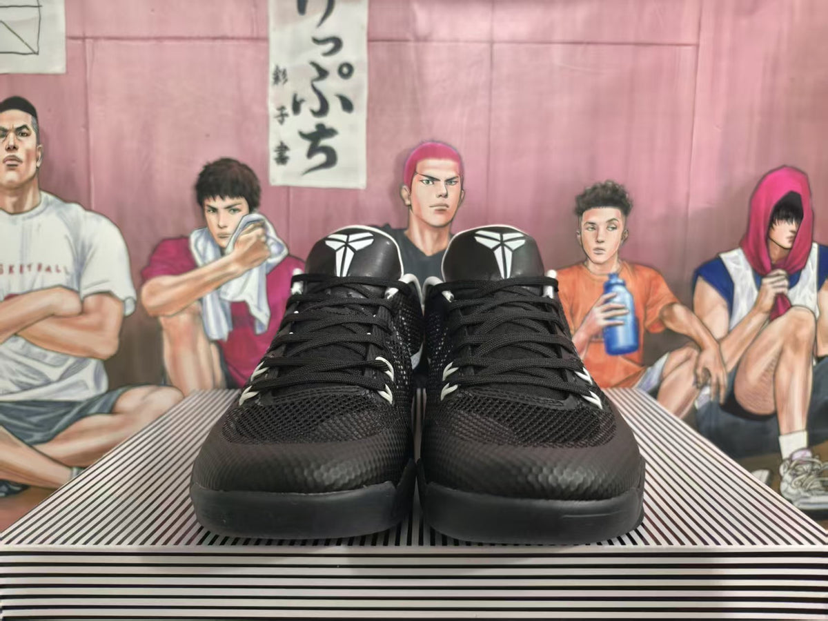 Front view of black Nike basketball shoes with white tongue emblems and black laces.