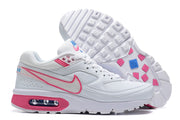 Side and outsole views of white Nike Air Max BW sneakers with pink accents and a visible heel cushioning window.