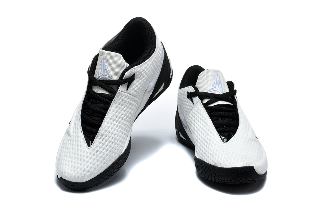 Pair of white and black Nike Kobe basketball shoes, shown from the front.