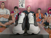 Front view of gray, black, and white Jordan sneakers with white laces and tongue logos.