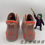 Rear view of the pair showing heel branding and red pull-tab details, with a display figure in the background.