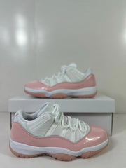 Close side view of the pink and white sneaker, showing the lacing structure and layered upper.
