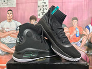 Pair of black Under Armour high-top basketball shoes with gray accents and white outsoles.