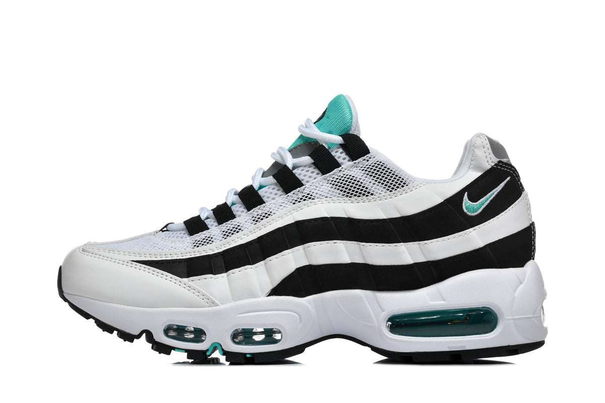 Side view of a black and white Nike sneaker with teal accents, layered wavy panels and visible cushioning windows.