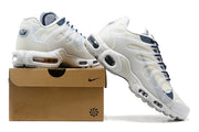 White and navy Nike sneakers displayed on a shoe box