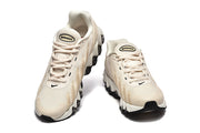 Pair of cream Nike Air Max DN sneakers shown from the front