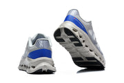 Rear view and outsole view showing blue heel panels and patterned tread.