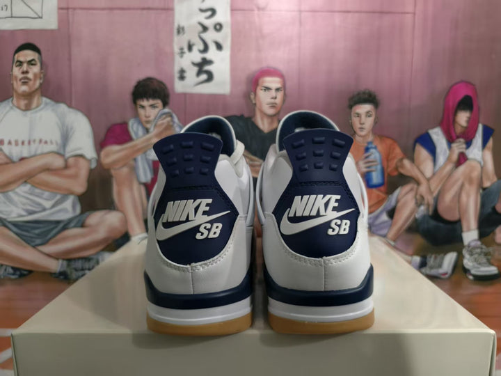 Rear view of white and navy sneakers showing Nike SB heel branding and gum-colored outsoles.