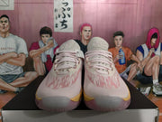 Front view of pink and light-colored Nike basketball sneakers with laces, textured uppers, and contrasting yellow outsole accents.