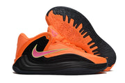 Orange and black Nike Giannis Immortality 7 shoe with outsole view