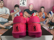 Rear view of rose-red Nike GT Cut sneakers showing perforated heel panels, black heel branding and the contrasting outsole.