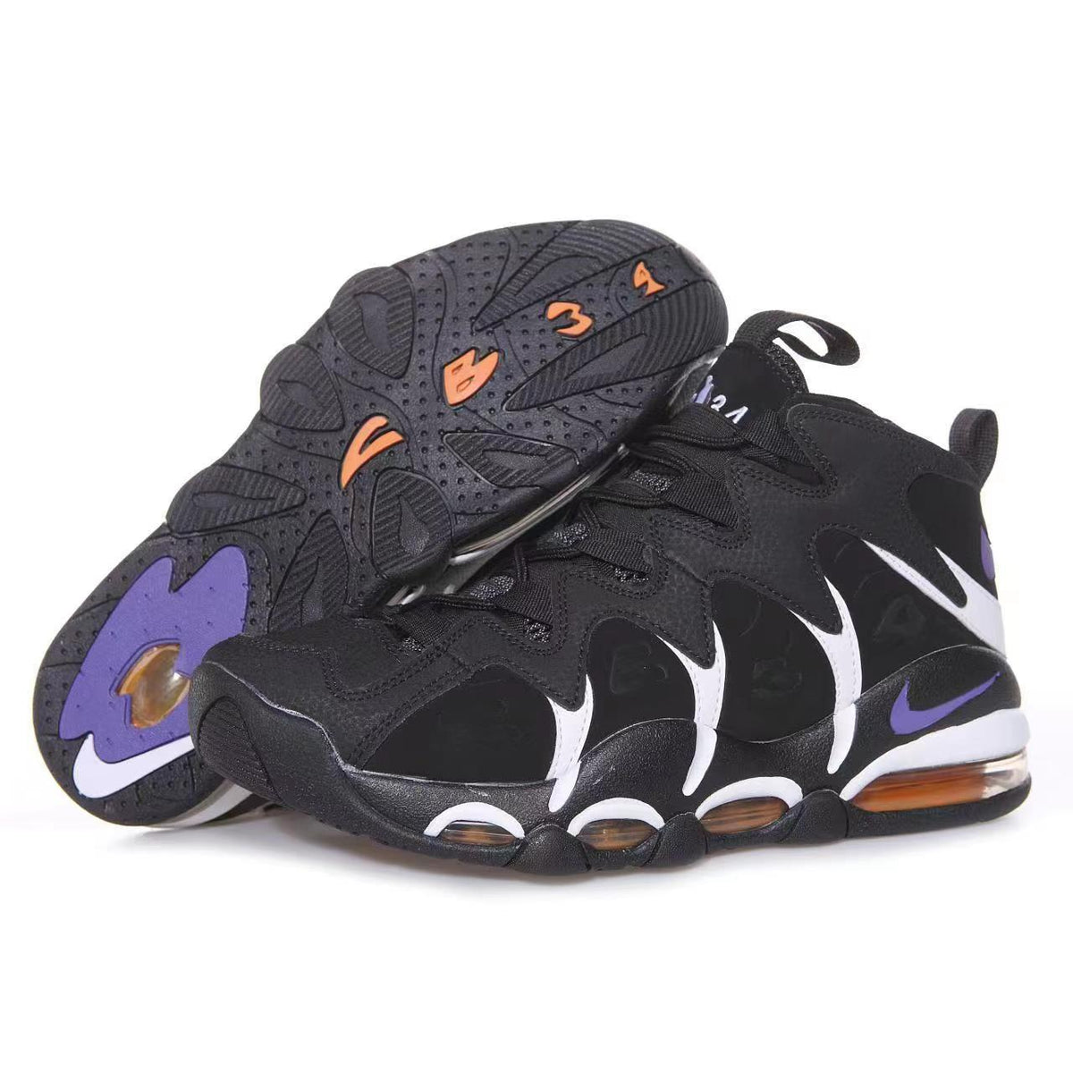 Pair of black Nike sneakers with white side accents, purple details, and visible sole cushioning