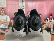 Rear view showing the purple heel panels, black heel details, and visible H-Flow marking.