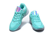 Front view of aqua Nike basketball shoes with iridescent tongue panels.