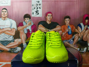 Front view of the volt green shoes showing the lace-up closure and textured uppers.