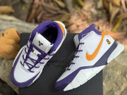 Top and side view of the white, purple and orange high-top sneakers displayed on a black box.