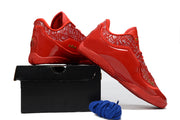 Red Nike LeBron 23 basketball shoes arranged over a black shoebox with blue laces.