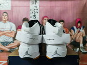 Rear view showing the ankle straps, heel Jumpman logos, white uppers, and gum-colored outsole edges.