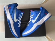 Top-down angled view of the pair displaying the blue, white, and red color scheme and outsole design.