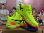 Angled view of a pair of neon yellow ASICS basketball sneakers with black branding and red outsole accents.