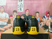 Rear view of black and yellow Jordan sneakers showing heel tabs and number 23 details
